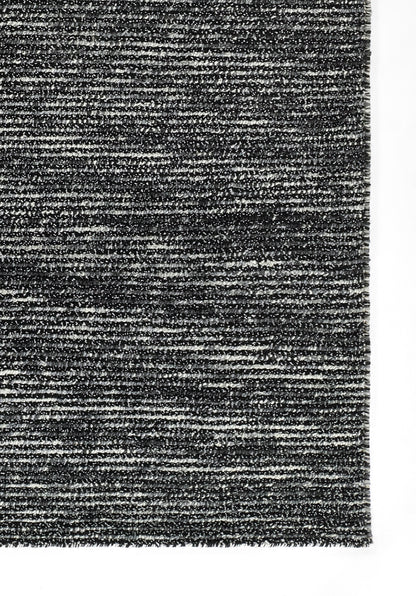 Dark gray heathered rug with a textured woven surface; contemporary chic, versatile for living rooms.