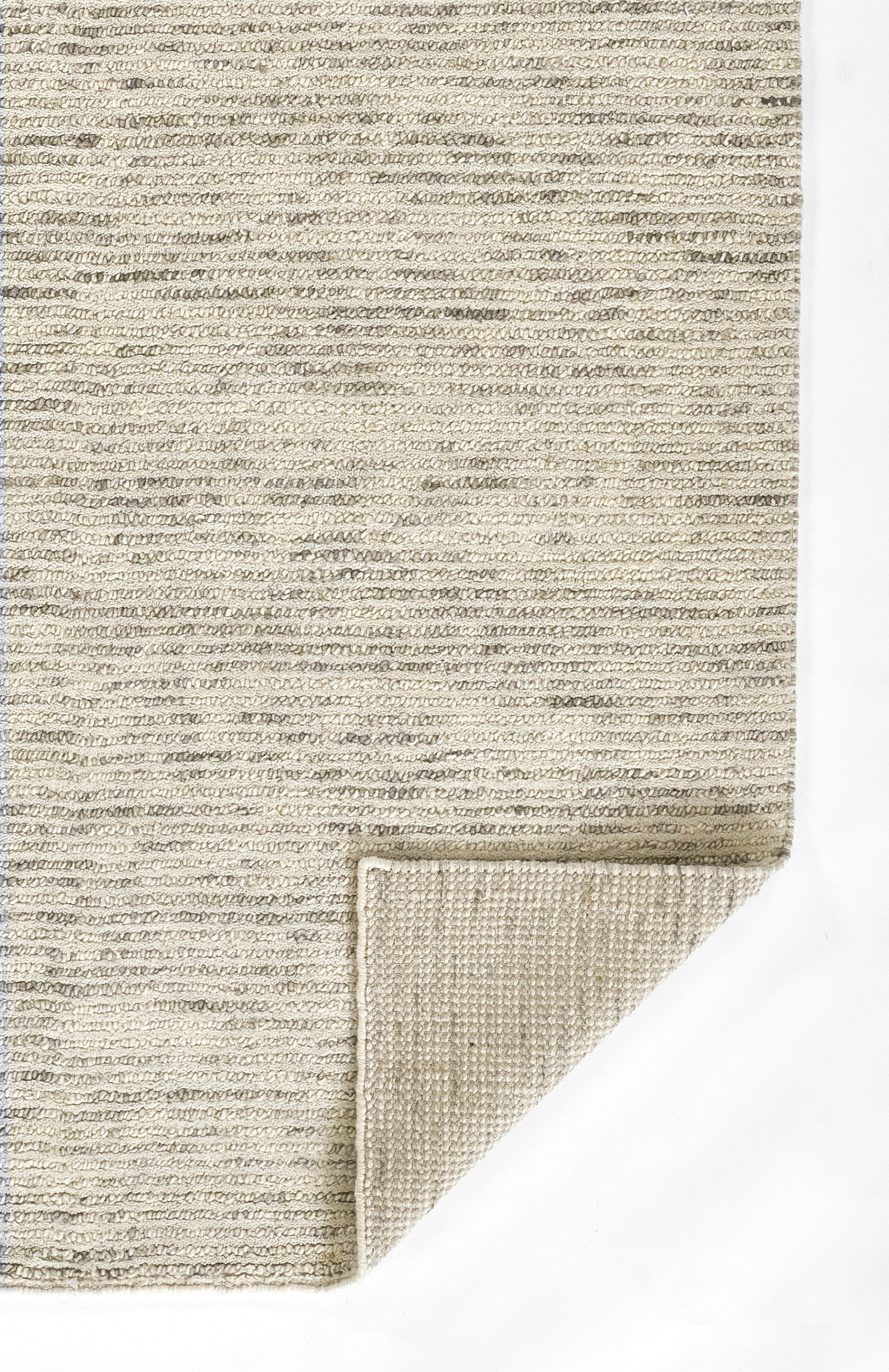 Beige loop-pile rug in cream tones; folded corner reveals lighter woven underside.