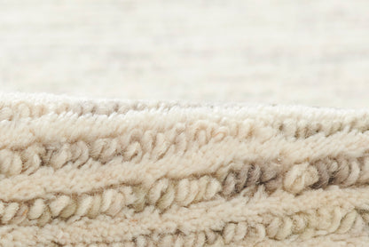 Cream beige chunky looped wool rug with plush textured surface
