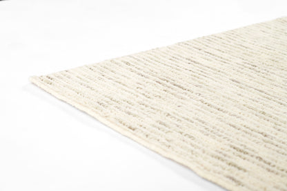 Cream textured shag rug with subtle beige stripes; plush pile for cozy floor decor.