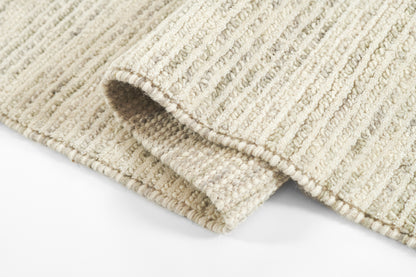 Beige cream rug runner with ribbed loop pile and subtle stripes, folded corner.