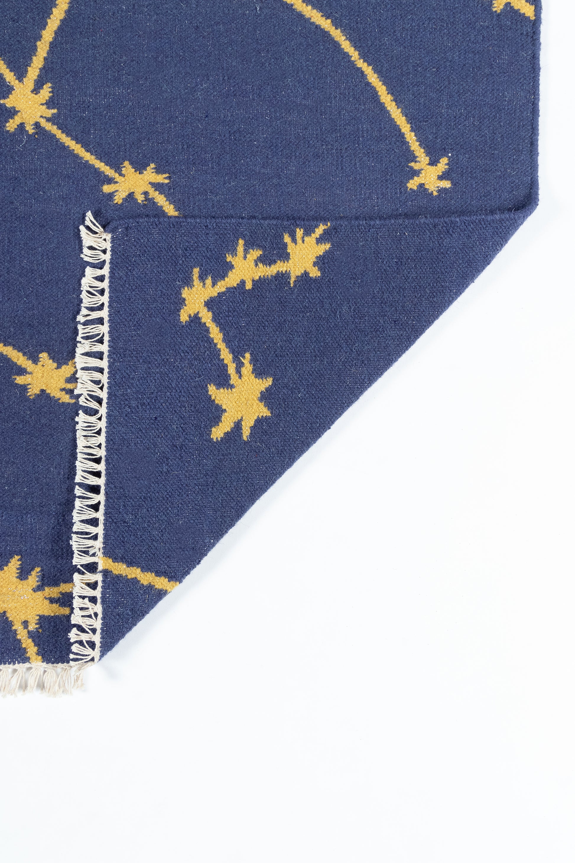 Navy rug with yellow star constellation print and fringed edges; 8' x 10'.