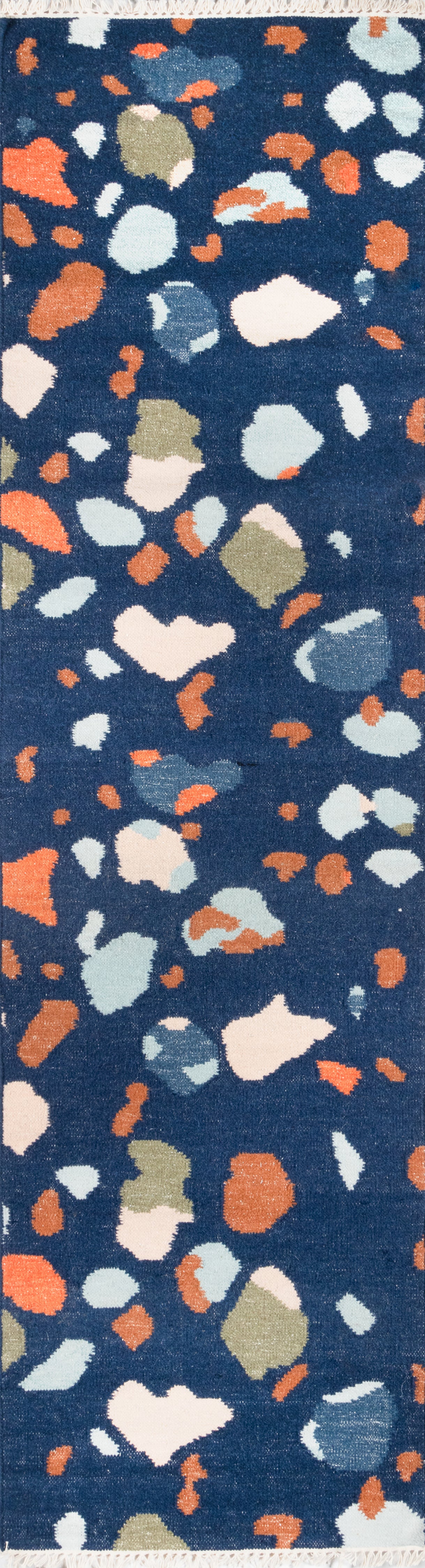 Navy blue terrazzo-inspired rug with multicolor irregular chips: white, coral, peach, olive, gray.