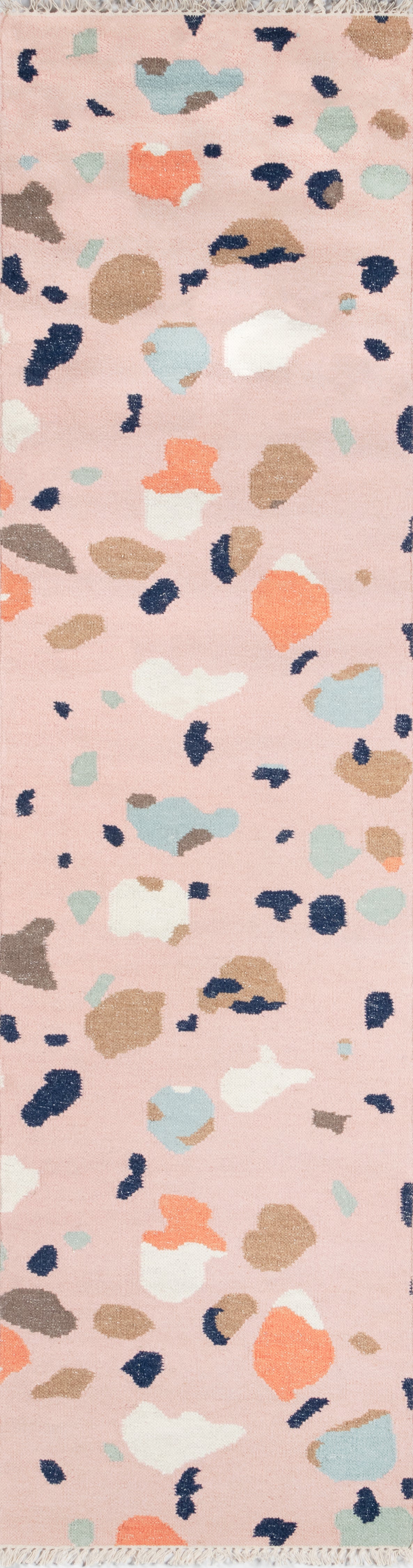 Pink terrazzo-inspired pattern on rug with irregular chips in peach, navy, beige, light blue and white.