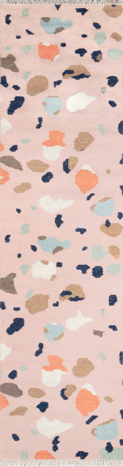 Pink rug runner with abstract terrazzo speckle print in navy, peach, beige, and light blue; soft, versatile.