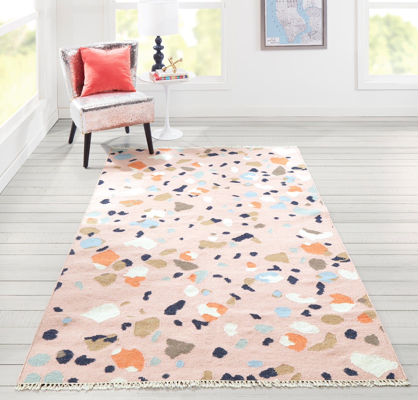 Rectangular pink runner with abstract multicolor spots in blue, orange, teal and beige, fringe, in a living room, 2' x 8'.