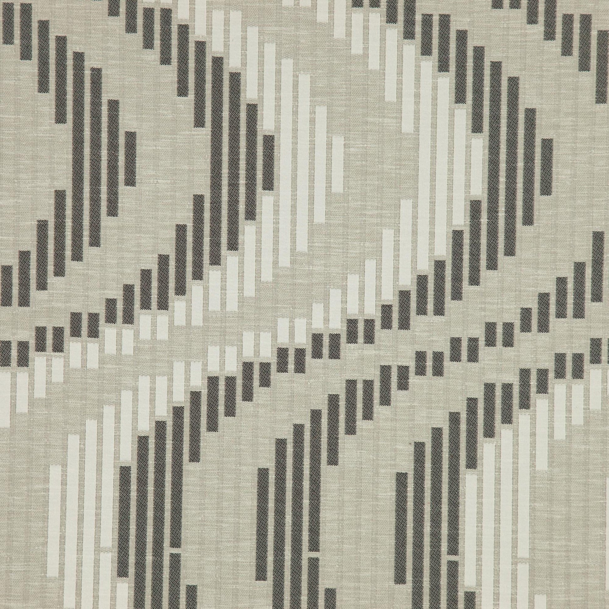 Black jacquard fabric with geometric scroll pattern and textured weave.