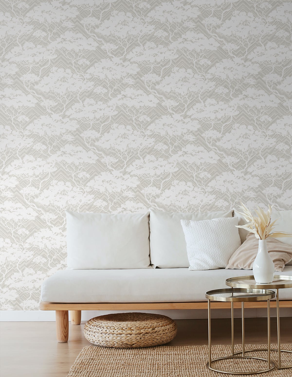 JP11708-A: Neutral living room featuring a stringcloth botanical rug in rustic grey matte, with white sofa, woven pouf, lace wallpaper, gold side table and vase with dried grasses.