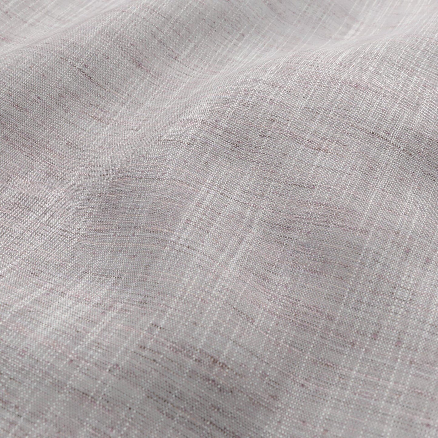 Close-up of soft pink, plum and ivory woven fabric with a sheer, draped texture.