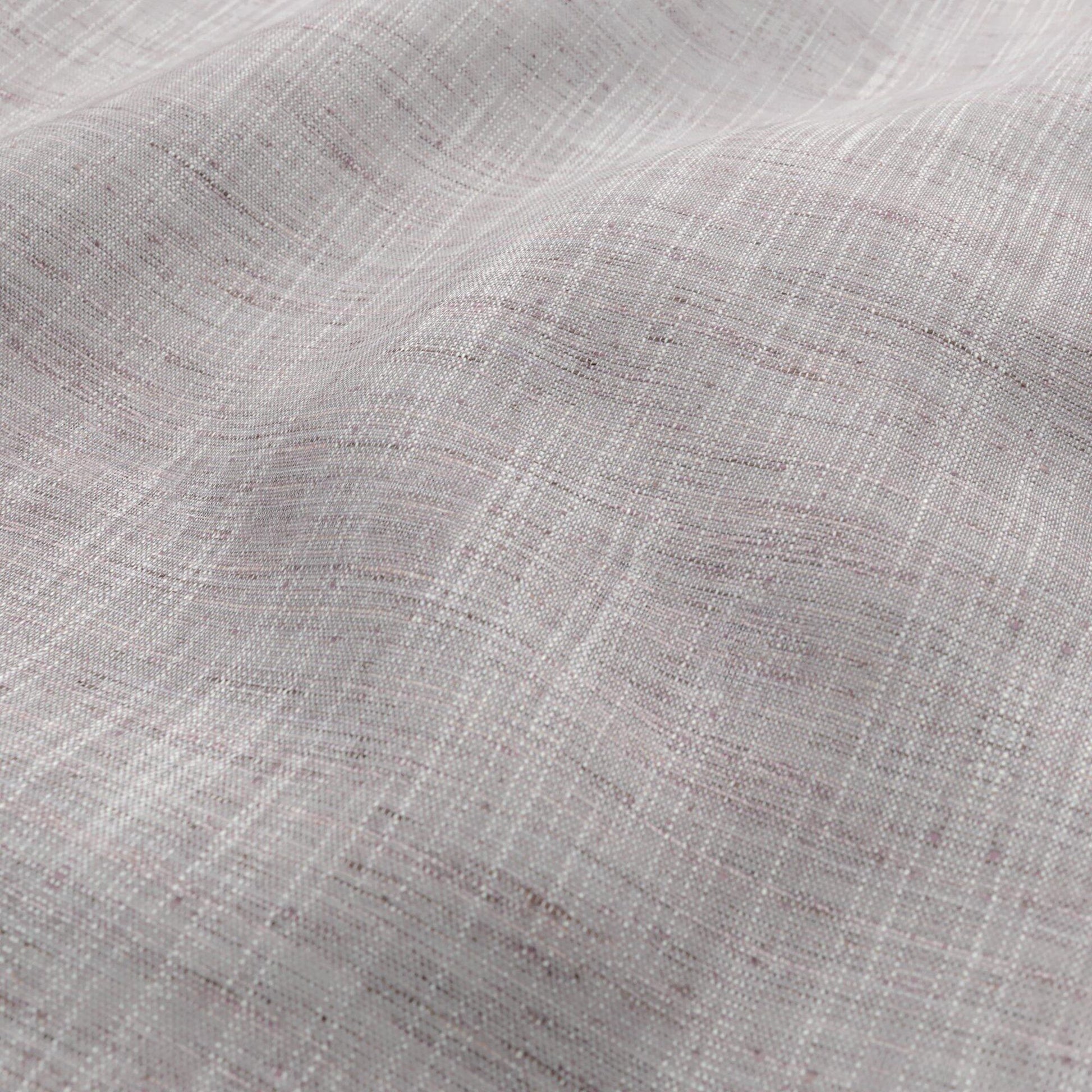 Close-up of soft pink, plum and ivory woven fabric with a sheer, draped texture.