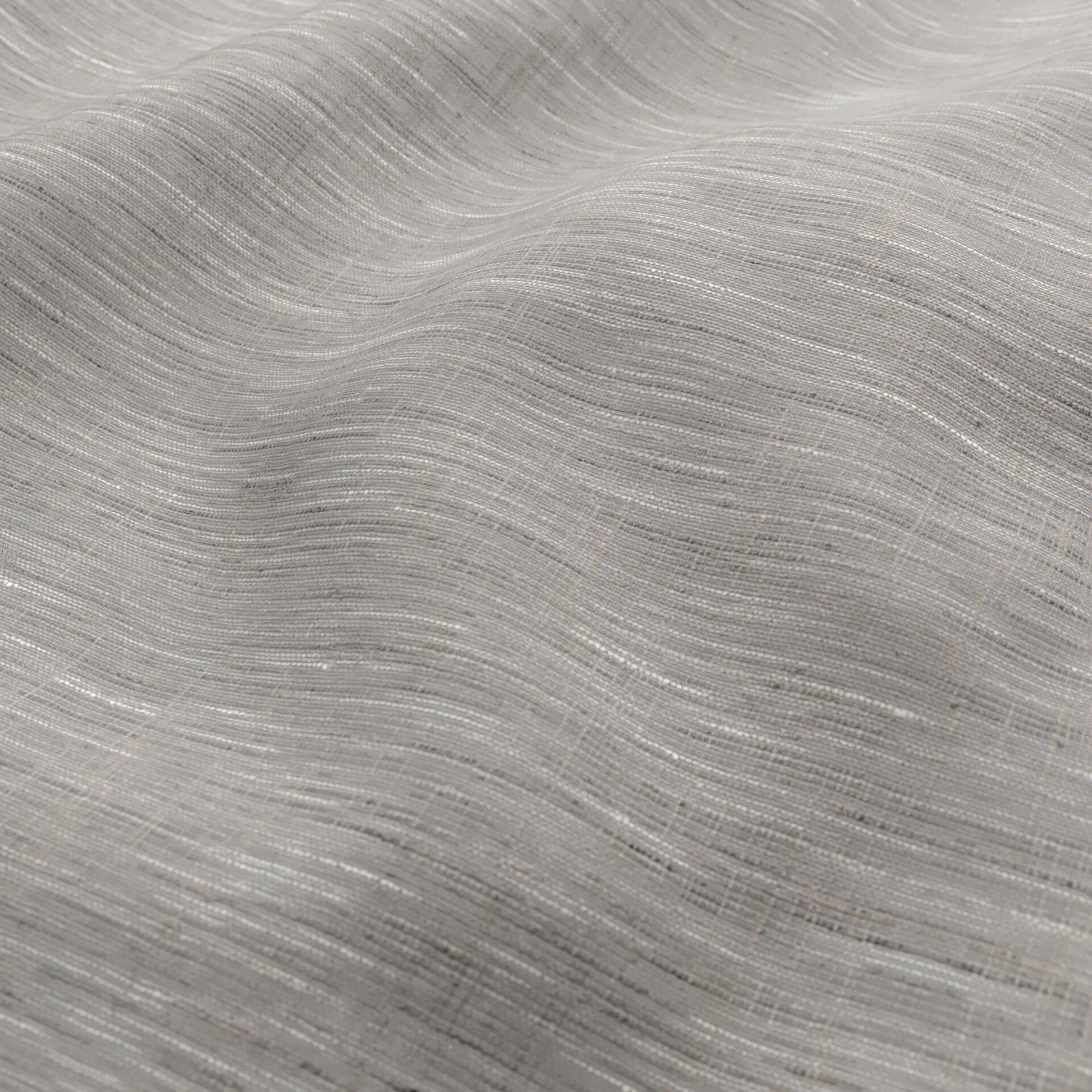 Light grey fabric with a subtle woven texture and soft drape; wide width, sheer fabric in grey, cream and beige.