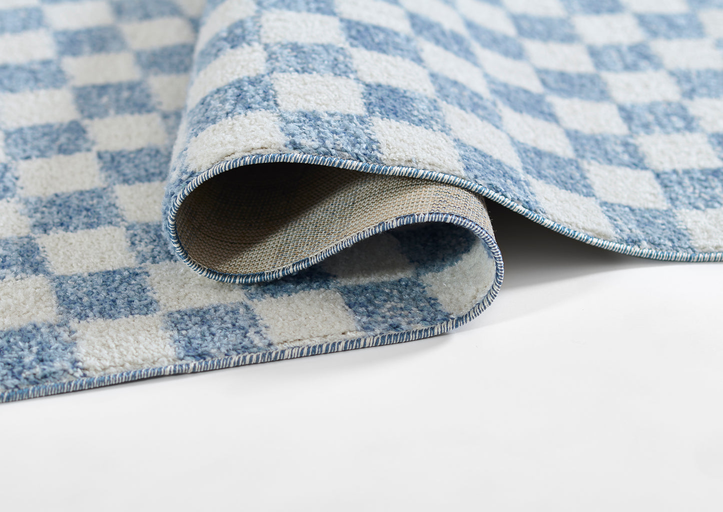 Blue and white checker plush rug with soft pile, curled edge, ideal for contemporary home decor