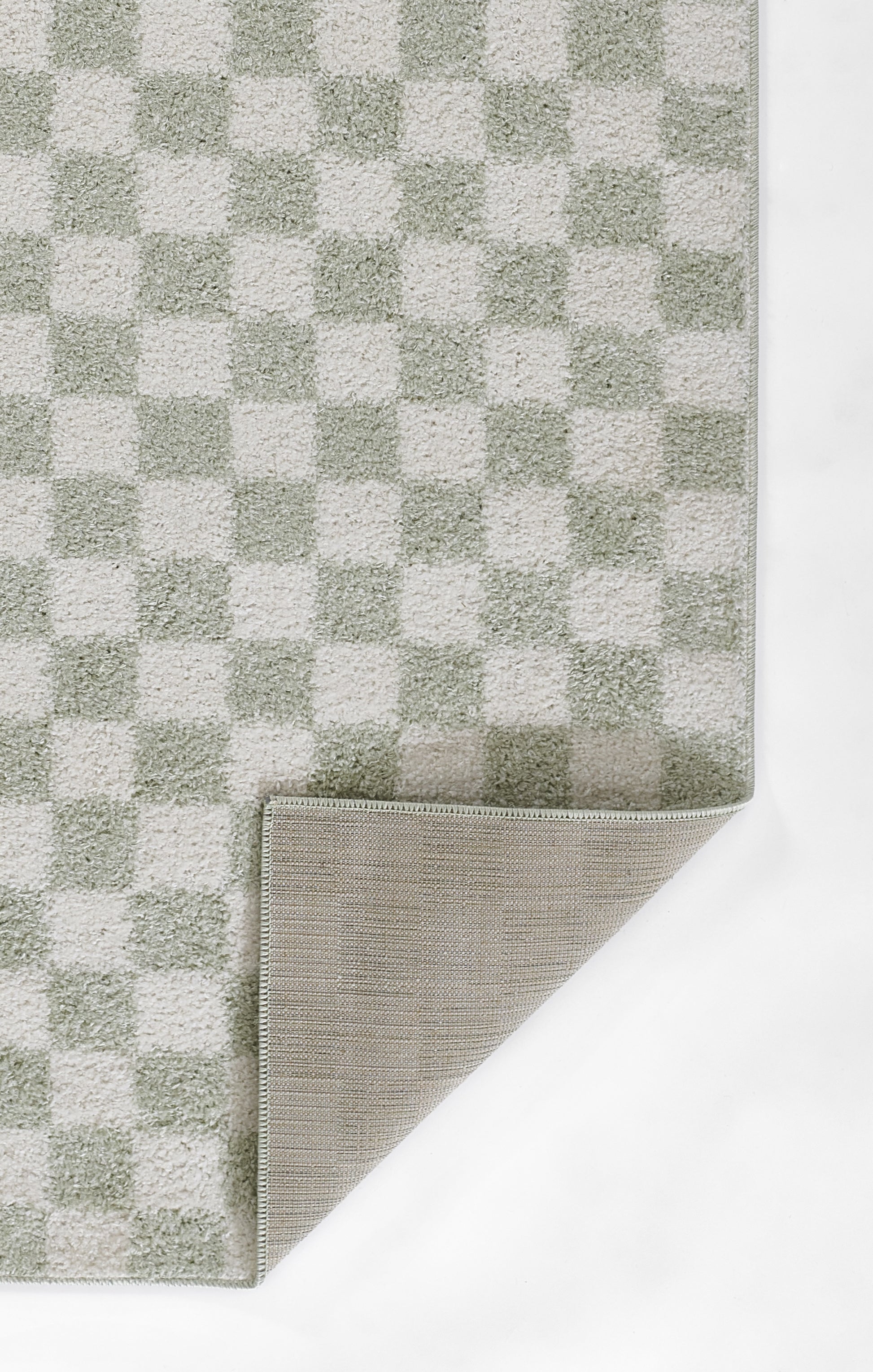 Gray checker-pattern rug with alternating light and dark squares; corner folded to reveal beige underside.
