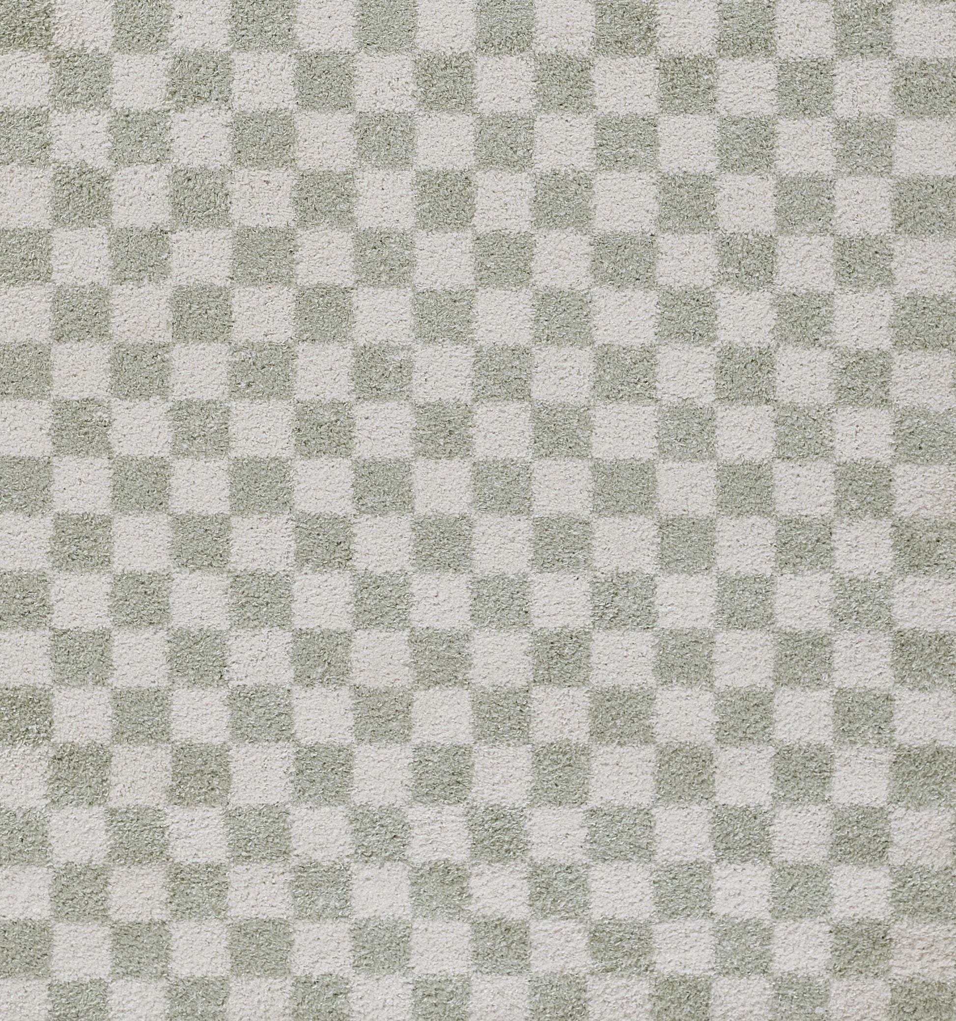 Green-gray and white checkerboard rug texture with a soft woven pattern.