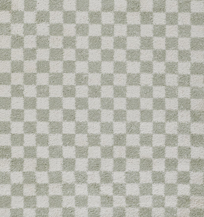 Green-gray and white checkerboard rug texture with a soft woven pattern.