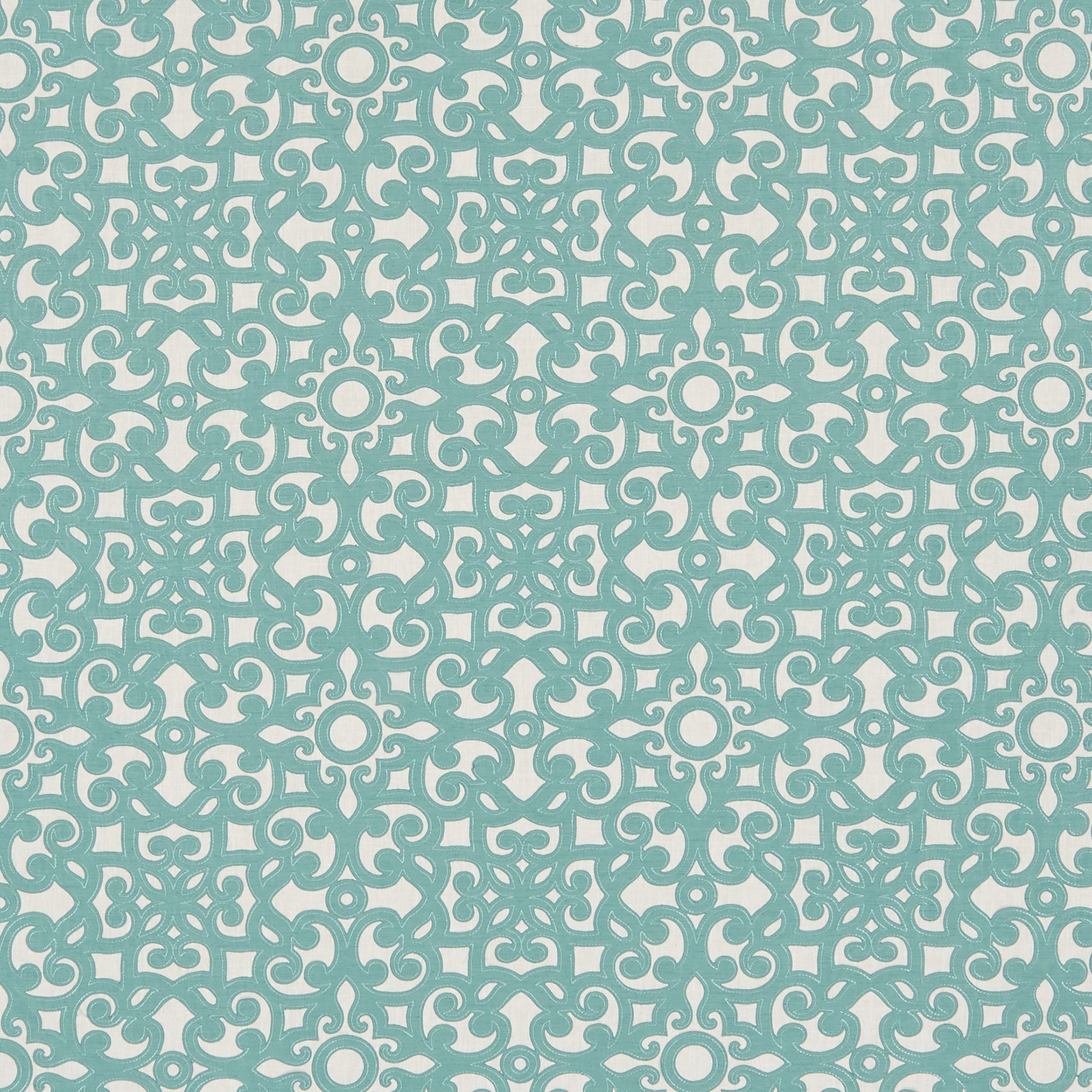Blue floral scroll embroidery on light cream fabric.