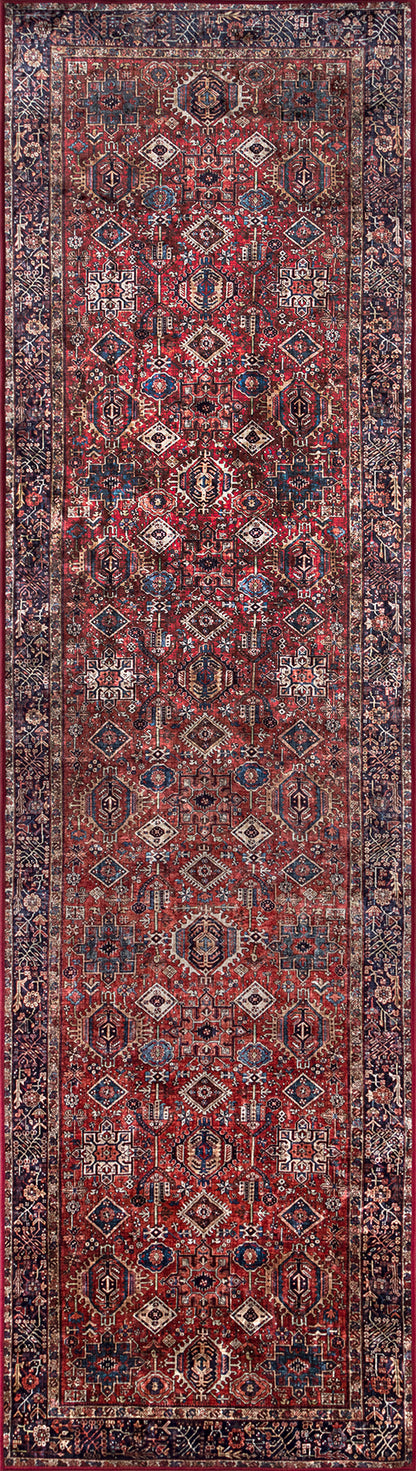Persian-style rug runner with red field, geometric diamond motifs, ivory and navy accents, and an ornate bordered edge.
