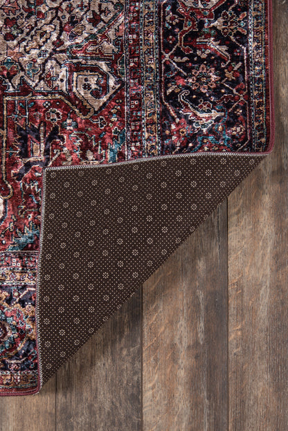 Karackar rug, rectangular, with red, blue, ivory Persian pattern; folded corner reveals brown dotted backing on wood floor.