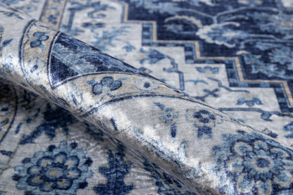 Blue and ivory oriental rug with floral motifs and zigzag border, folded corner.