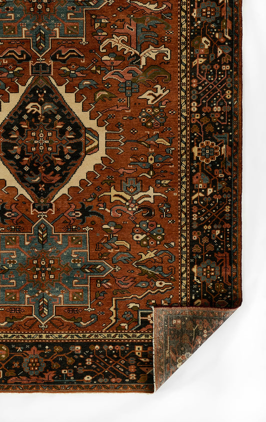 Red Karaj rug with teal and ivory geometric medallion, ornate dark border; Persian-inspired geometric design.