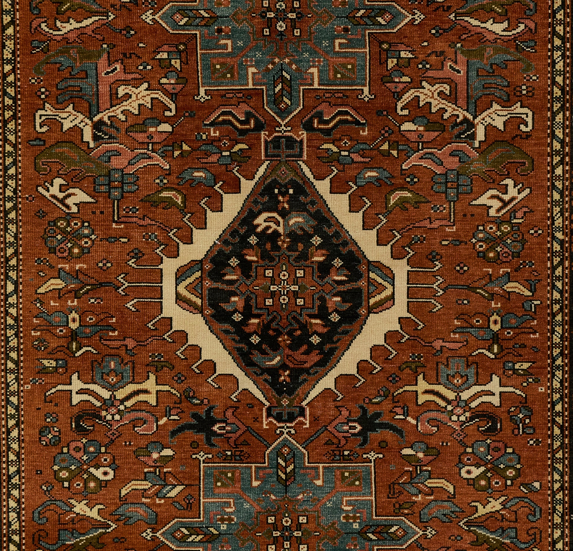 Karajkaj rug with rust-red field, central diamond medallion, teal and ivory accents; ornate geometric floral border.