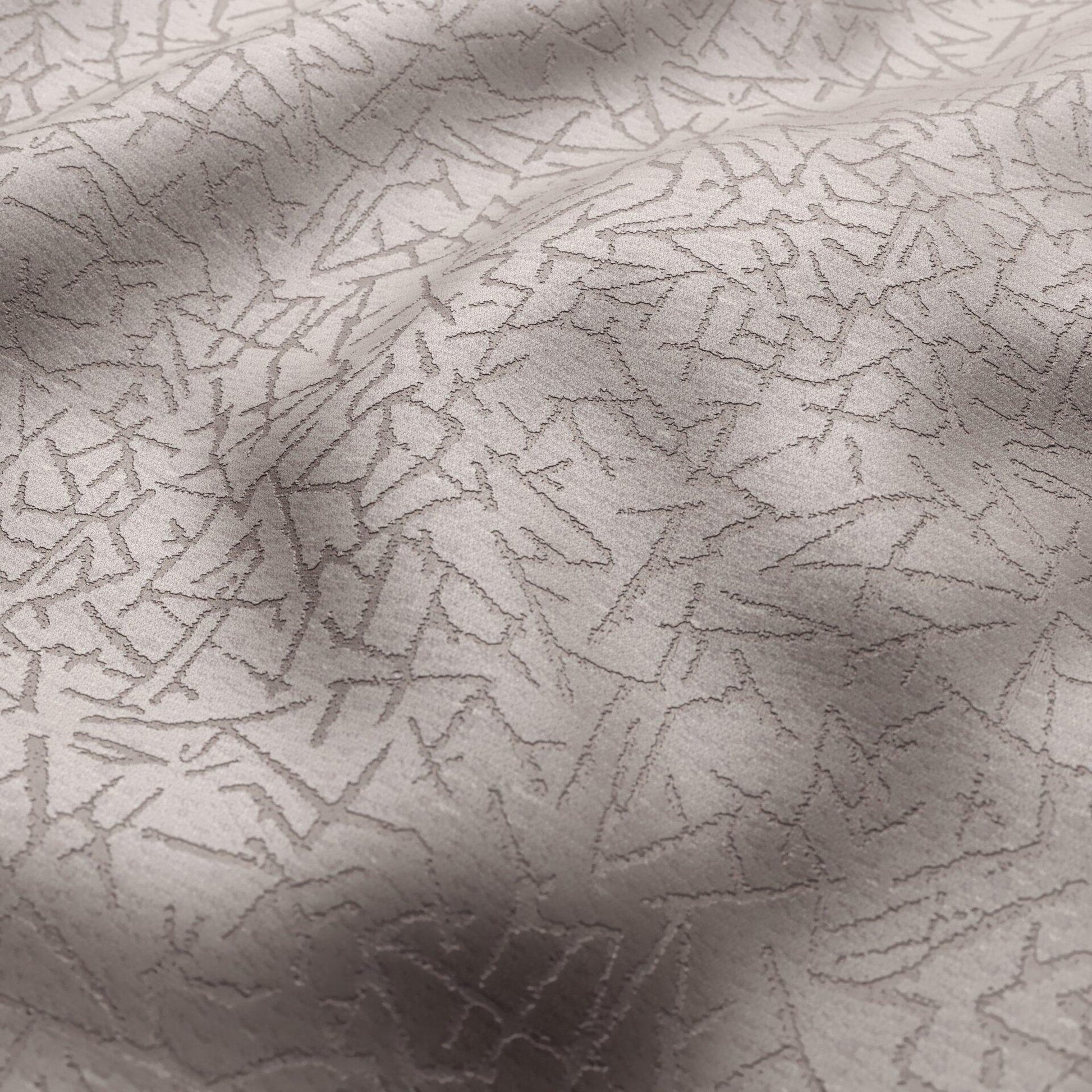Abstract silver velvet fabric with a subtle jagged geometric pattern and soft nap; ideal for upholstery or drapery.