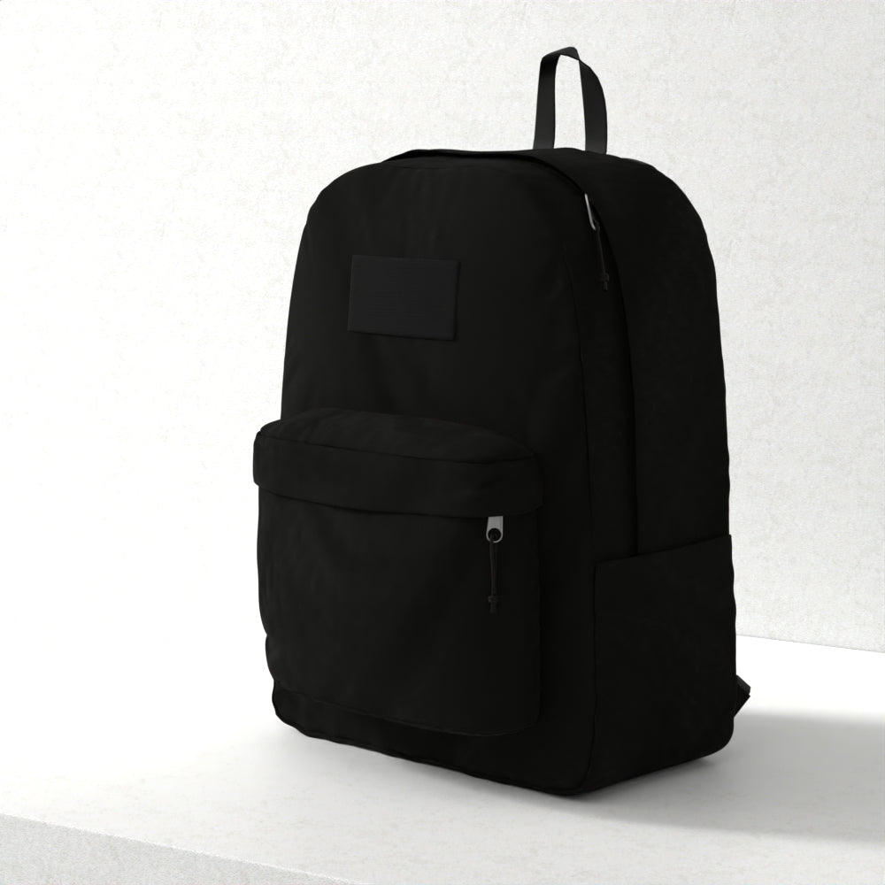 Black fabric backpack with front zip pocket, top loop handle, and minimalist patch for everyday use.