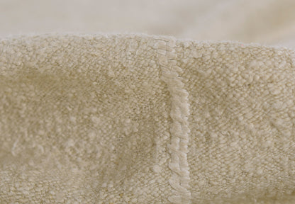 Cream rug with stitch pattern and plush texture; visible seam; size 5' x 8'.