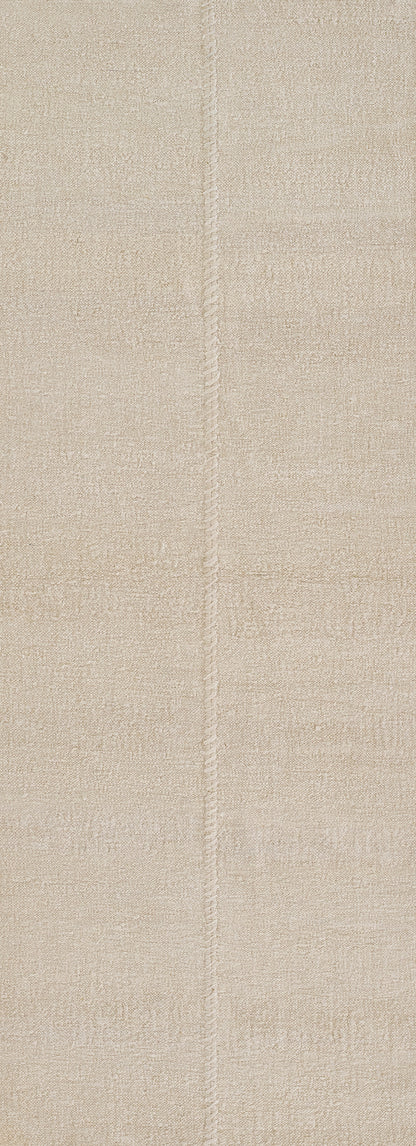 Beige textured area rug with a central seam, plush pile and neutral warm tone.