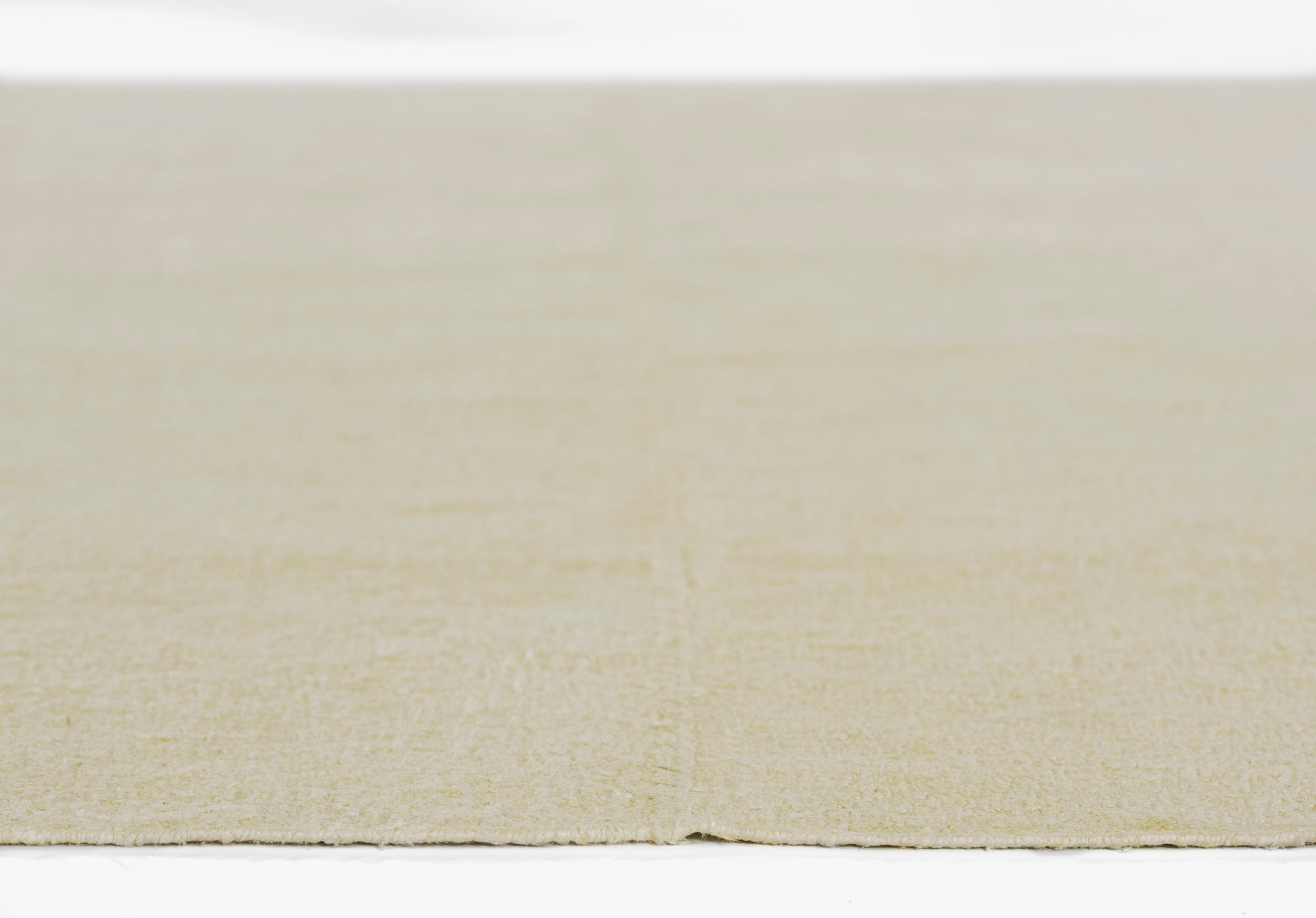 Beige flat-weave rug with a soft cream texture; rectangular floor decor for living spaces; 5' x 8'.