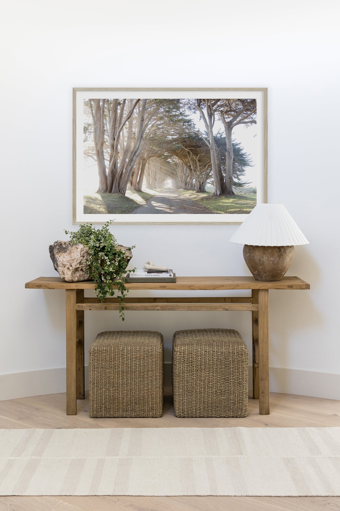 Muted stripe rug laid on the floor in a soft, neutral palette with a long rectangular shape.