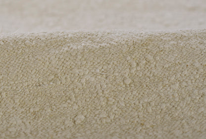 Beige plush carpet pile close-up with dense looped fibers, cozy home rug texture.