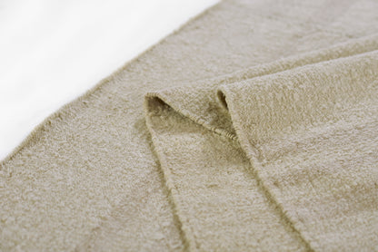 Beige rug with a muted stripe pattern; soft, plush surface; 8' x 11' area rug.