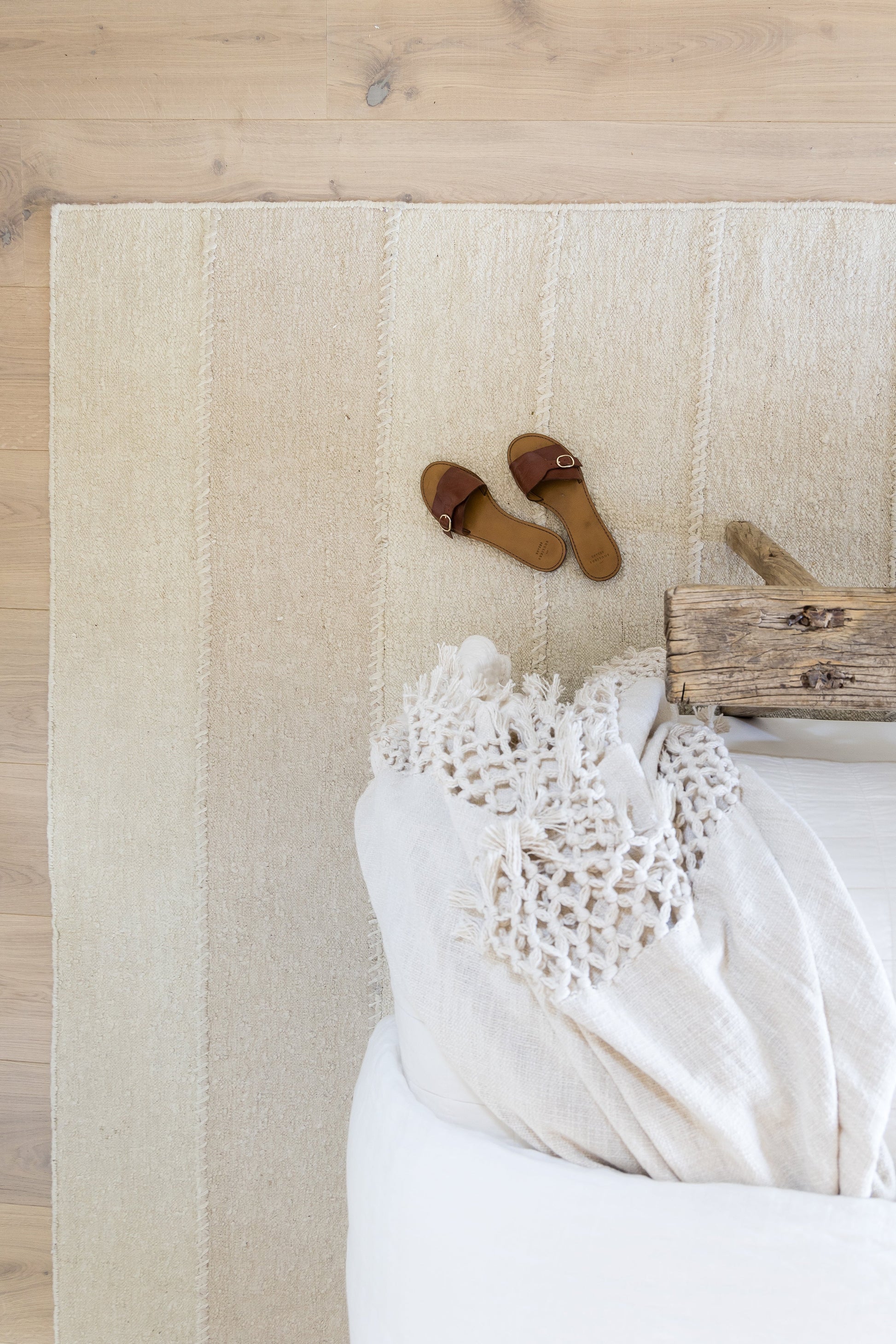 Beige striped area rug on light wood floor, 5' x 8'.