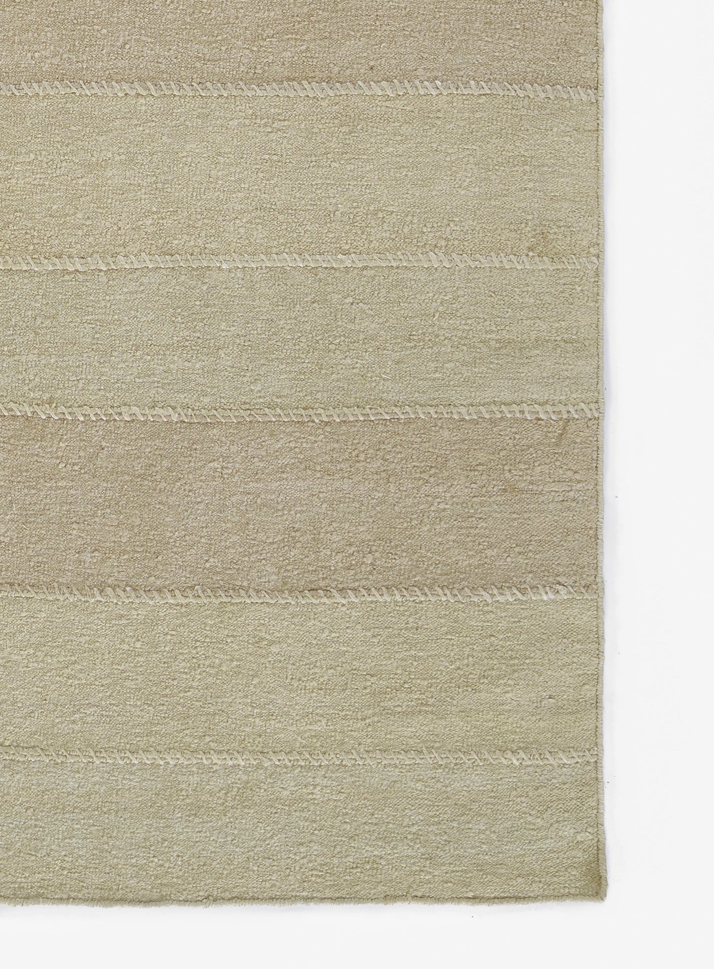 Beige rectangular rug with plush pile and subtle horizontal stitched stripes for a modern minimalist look.