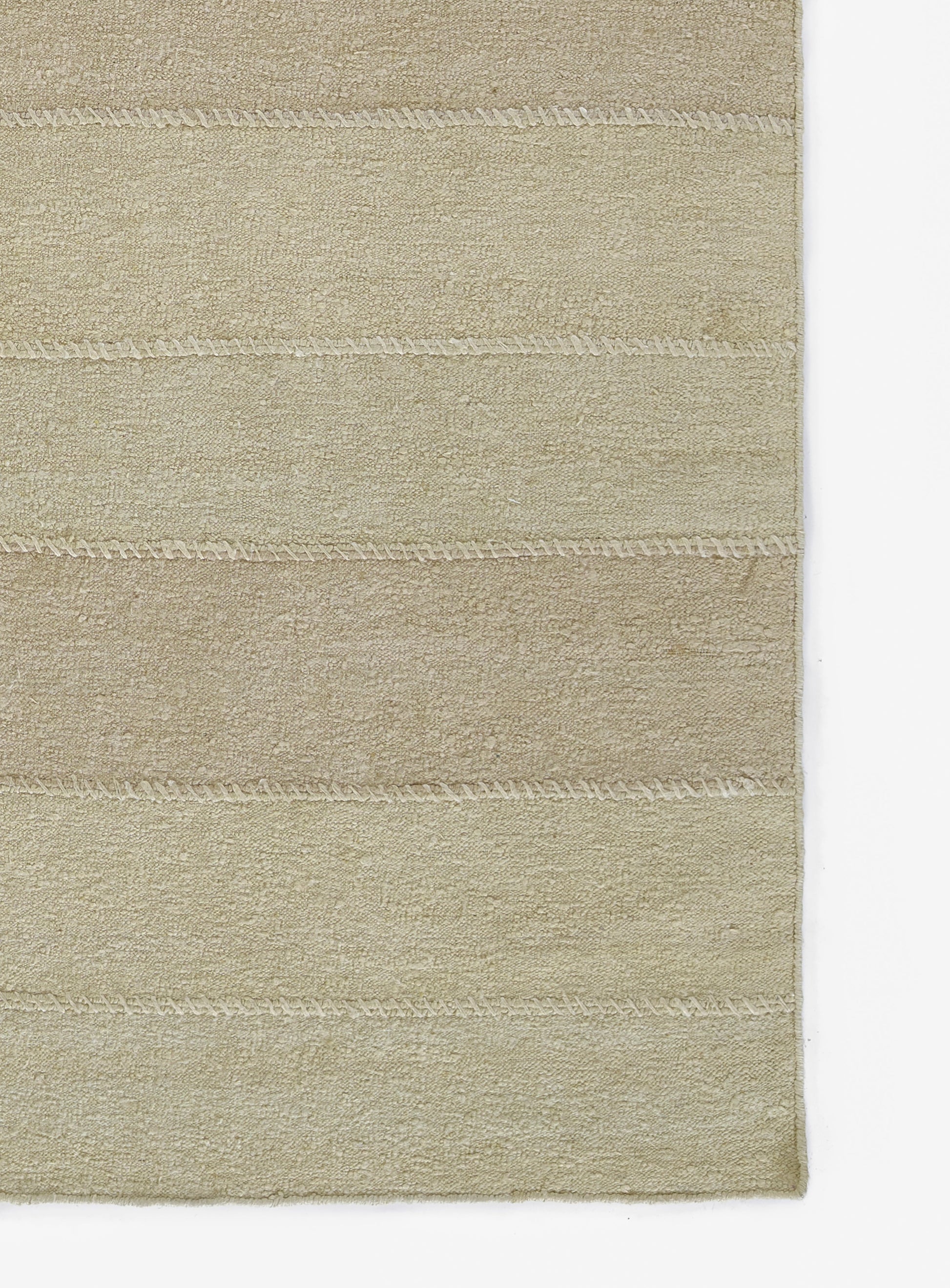 Beige rectangular plush rug with subtle horizontal stitched bands; soft dense pile for living room or bathroom.