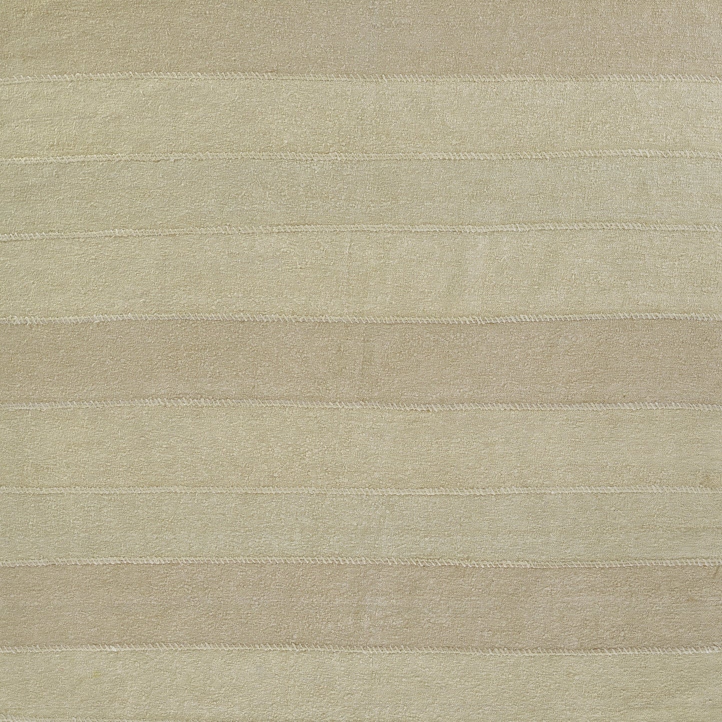 Beige rug with pale horizontal stripes; plush, soft texture underfoot.