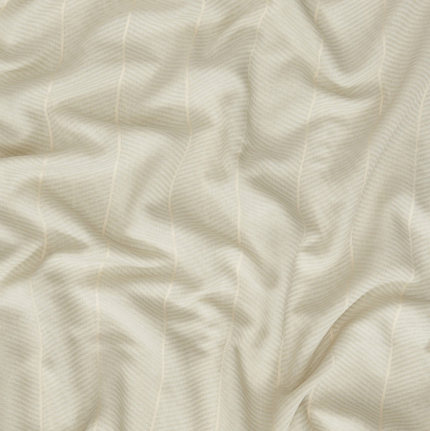 Cream textured fabric with subtle diagonal rib pattern and soft drape; versatile for clothing or home decor.