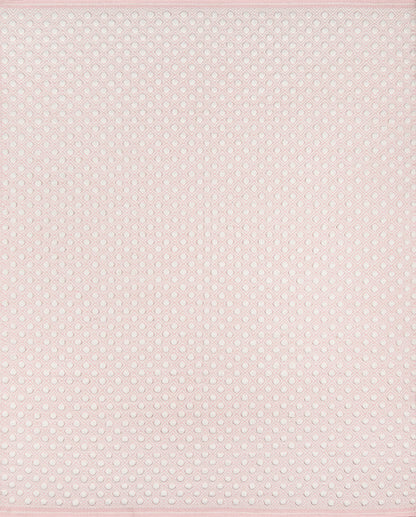 Soft pink dotted mesh fabric with tiny white eyelets; delicate sheer material for dresses, blouses, or lingerie accents.