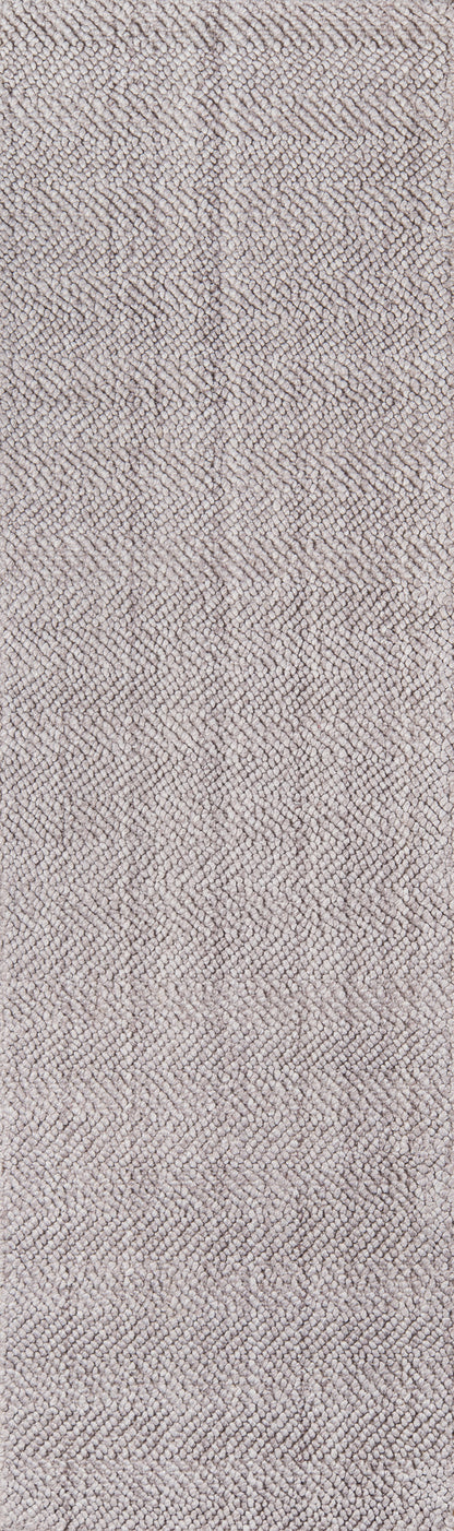 Beige-brown herringbone woven tweed rug close-up; textured surface.