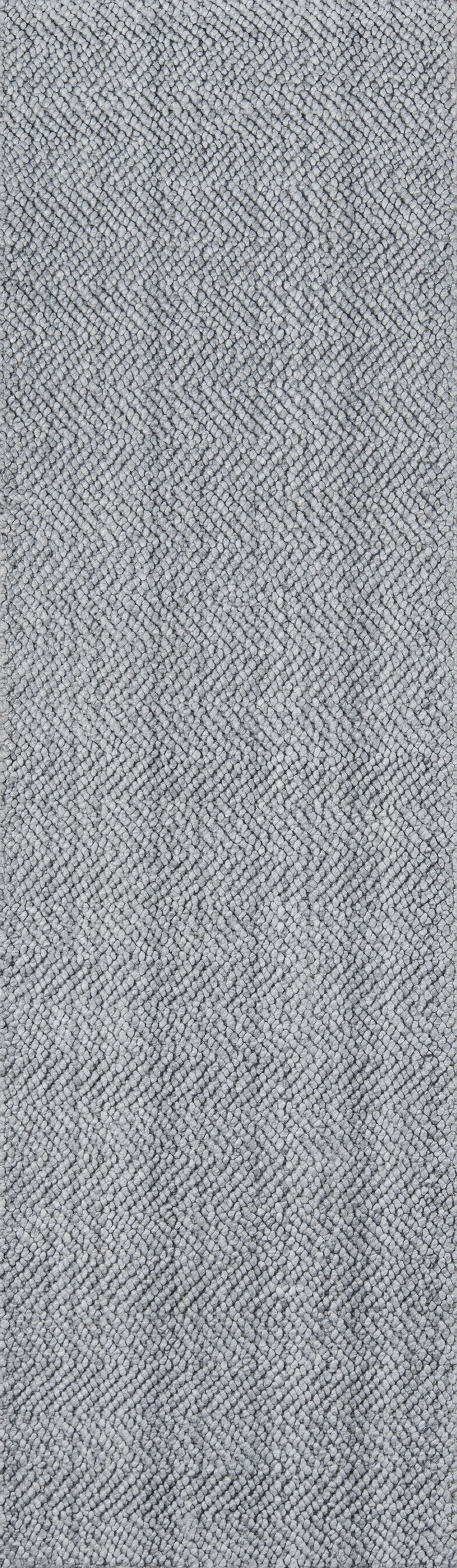 Gray herringbone woven rug texture with a subtle chevron pattern.