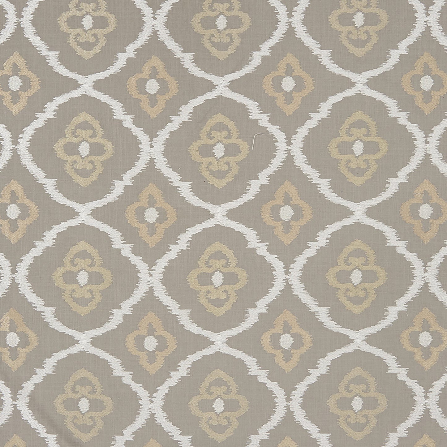 Taupe fabric with white arched lattice and quatrefoil motifs and beige floral centers; damask-style embroidery in grey and silver.