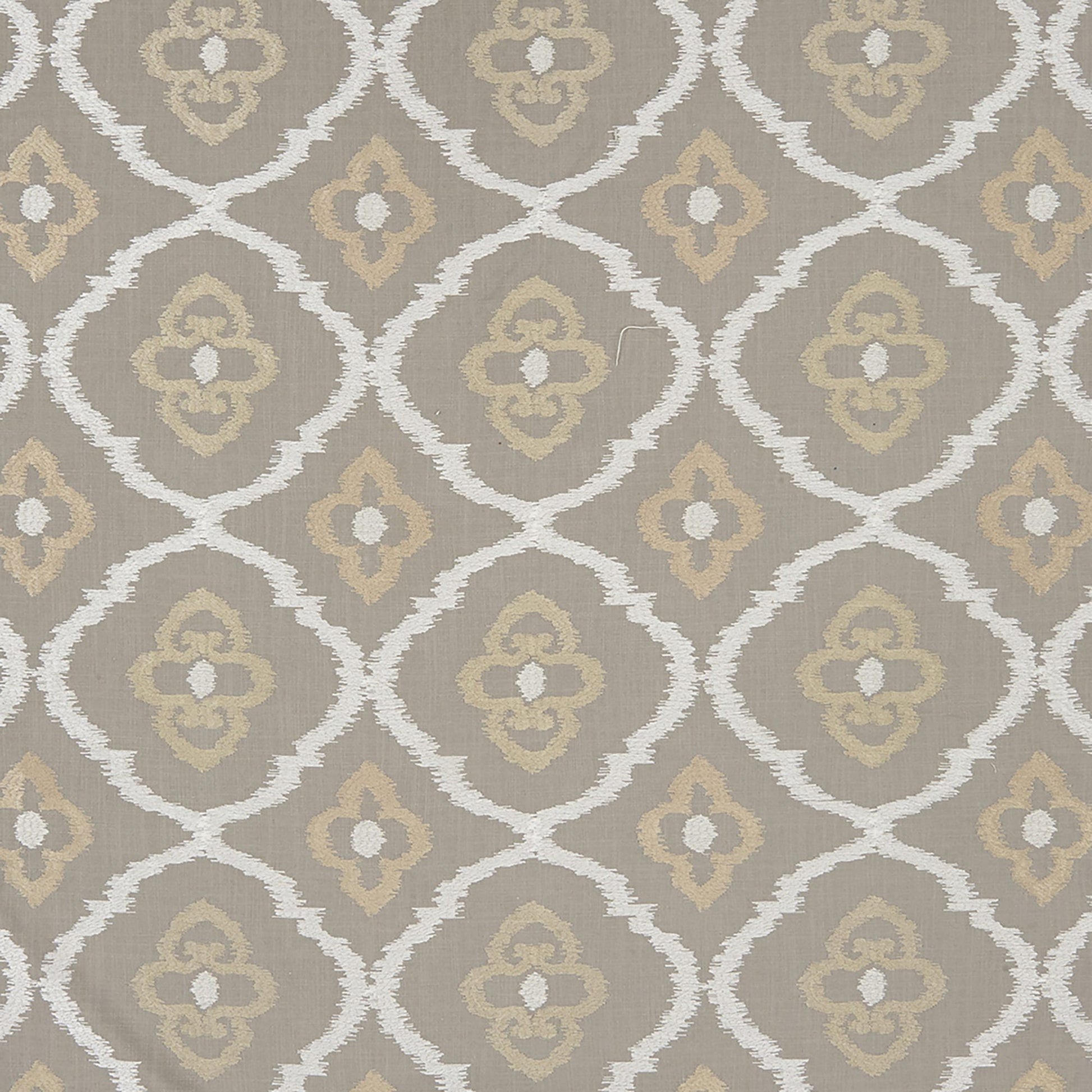 Taupe fabric with white arched lattice and quatrefoil motifs and beige floral centers; damask-style embroidery in grey and silver.