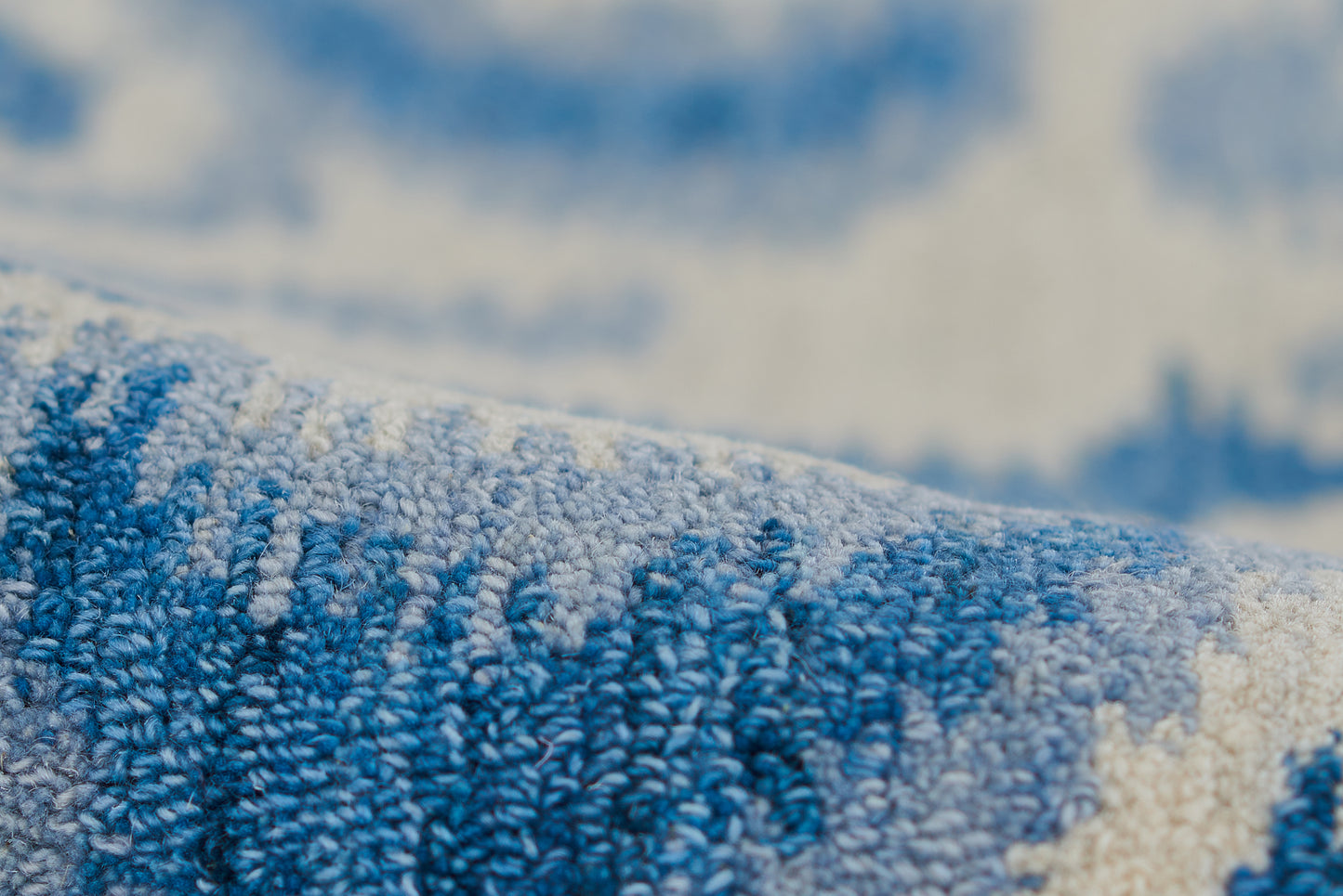 Close-up of a blue and white cotton terry towel with fluffy loop pile.
