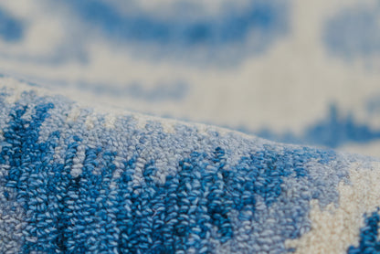 Blue and white woven rug with soft loop pile texture.