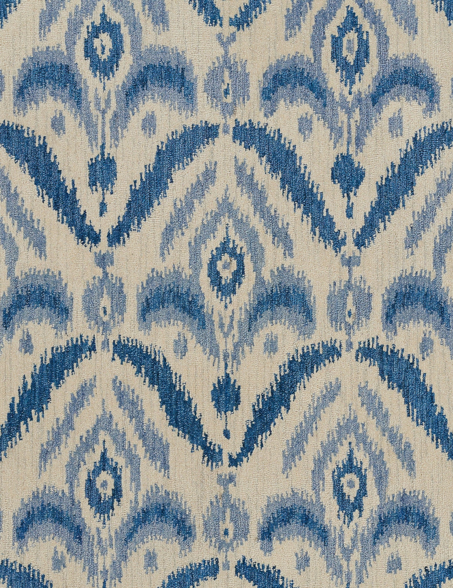 Ikat-inspired blue & beige woven fabric with repeating diamond motifs & chevron arches.