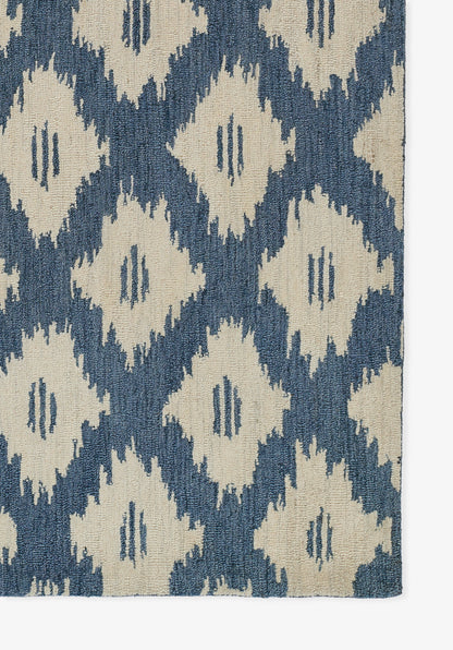 Blue and cream ikat diamond-pattern rug with woven texture.