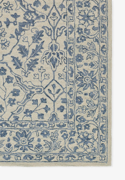 Beige area rug with blue intricate floral oriental pattern and bordered edge.