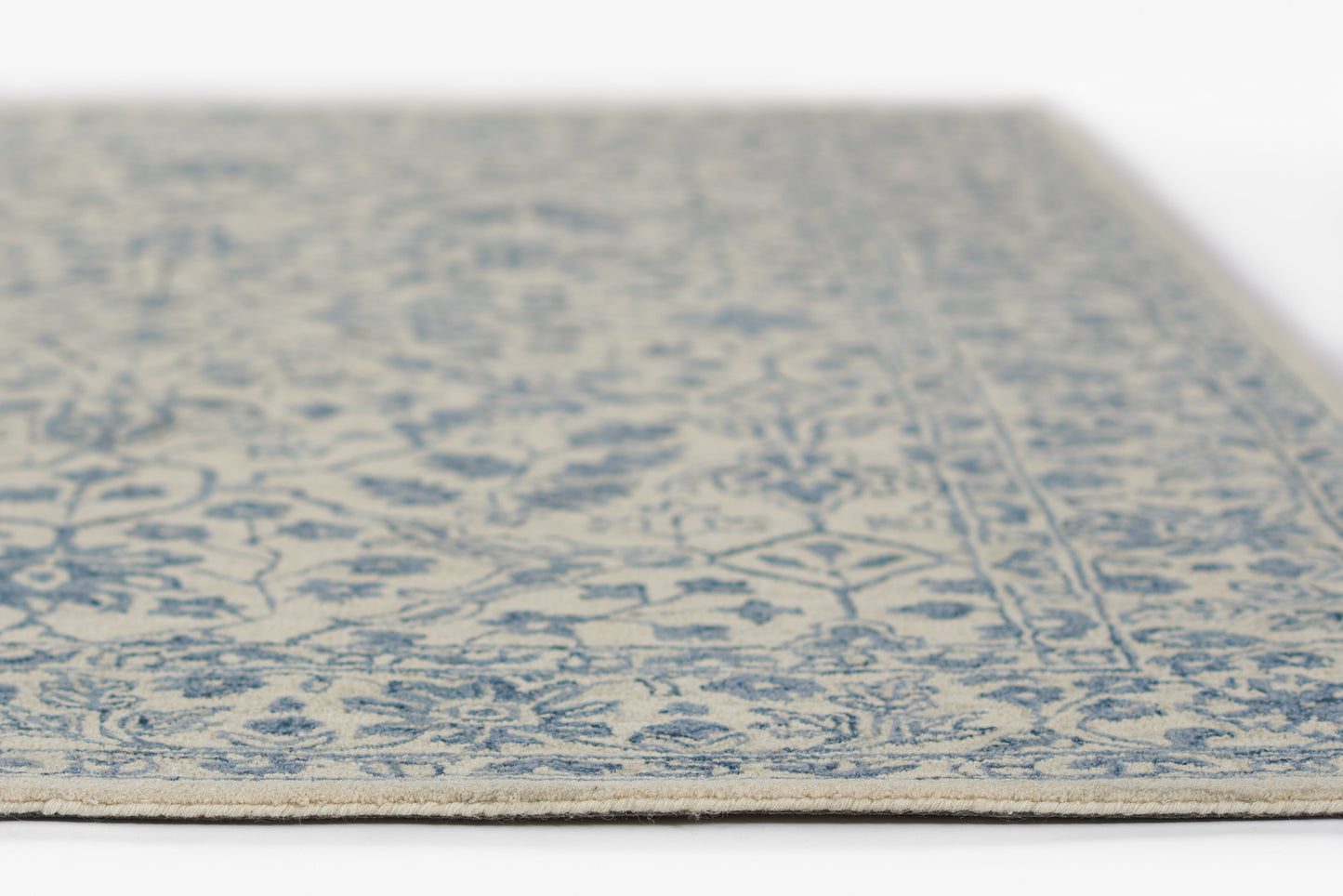Leidelei blue and ivory oriental rug with floral border, beige fringe, rectangular woven rug.