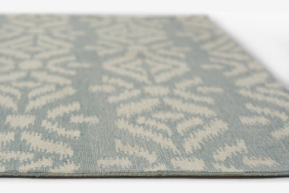 Blue-gray rug with ivory ikat-inspired geometric pattern; rectangular floor rug with low pile.